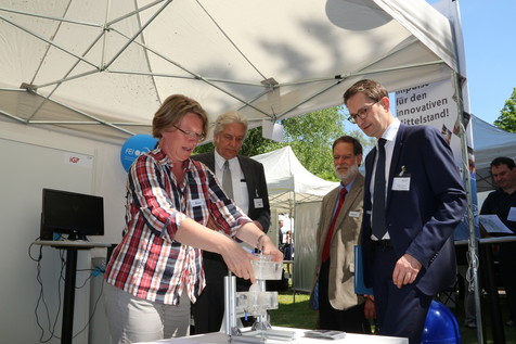 Station 2 des Abteilungsleiterrundgangs: Der FEI-Stand mit Vorstellung eines Best-Practice-Projekts aus der IGF. Prof. Peggy Braun erklärt MinDirig. Stefan Schnoor (rechts) die Versuchskammer für die Anwendung der Plasmatechnologie zur Entkeimung von Eiern. Station 2 des Abteilungsleiterrundgangs: Der FEI-Stand mit Vorstellung eines Best-Practice-Projekts aus der IGF. Prof. Peggy Braun erklärt MinDirig. Stefan Schnoor (rechts) die Versuchskammer für die Anwendung der Plasmatechnologie zur Entkeimung von Eiern.